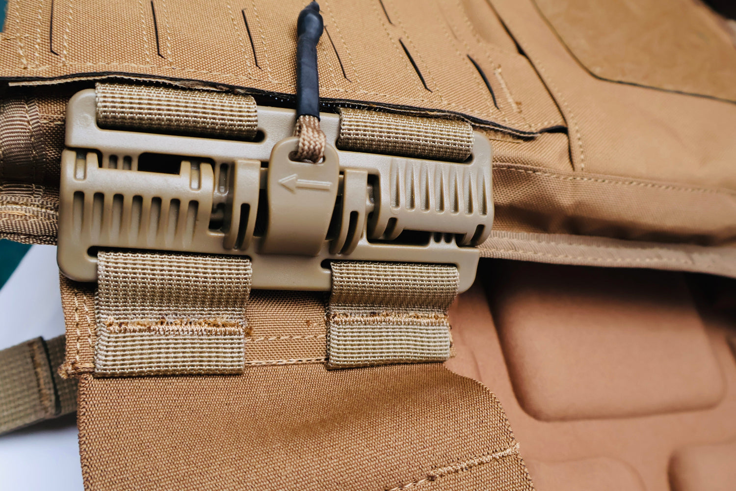 Close-up of a QRB Buckle tactical vest with multiple straps and buckles.