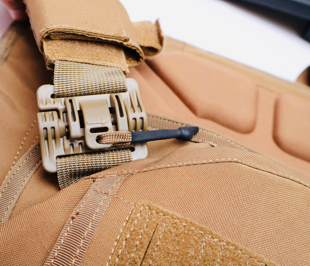 Close-up of a tan tactical Vest with a Shoulder strap and Quick release buckle.