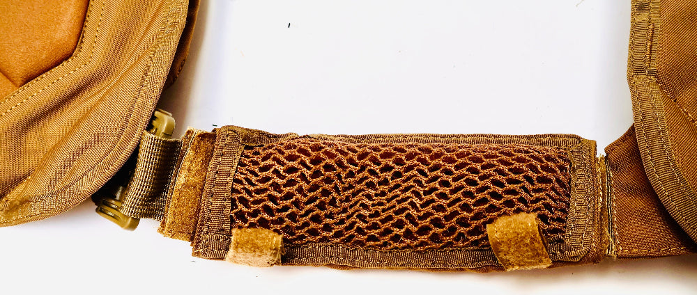 Close-up of a brown shoulder strap or belt with a 3d mesh strap on a white background
