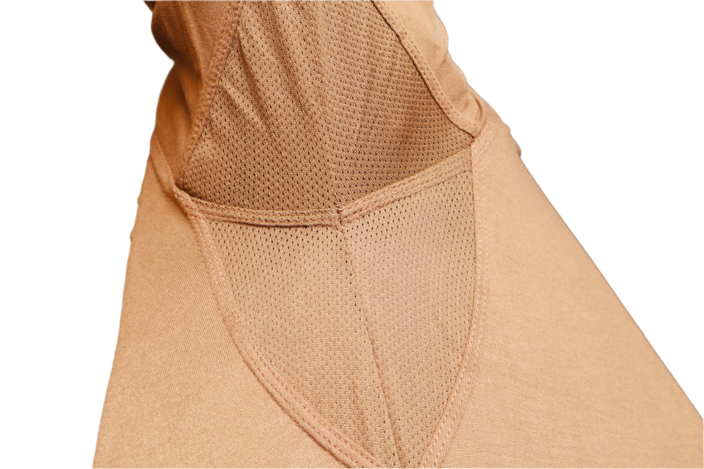Close-up of a beige garment with underarm mesh for ventilation or air movement detailing on a white background