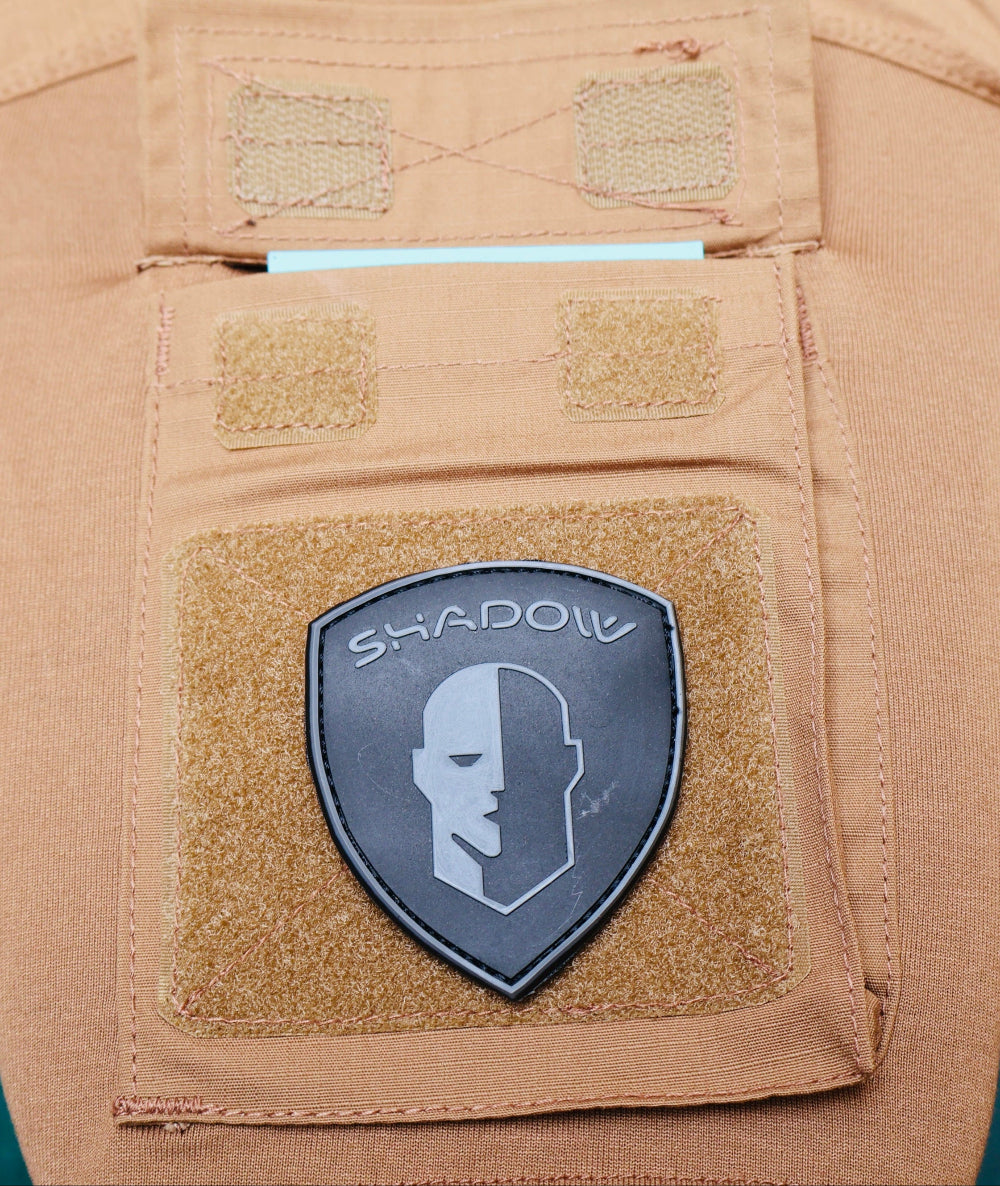 Tactical patch with 'Shadow' logo on a tan background