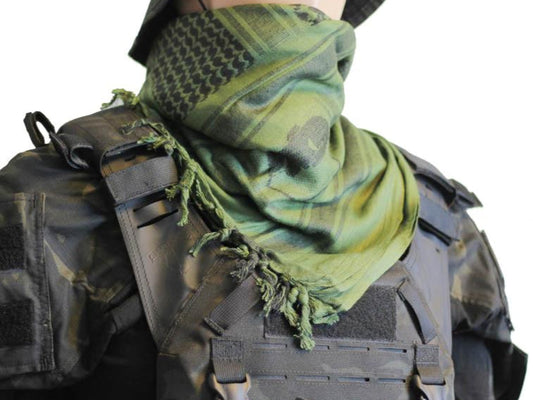 A person wearing a camouflage tactical military scarf on their head and neck.