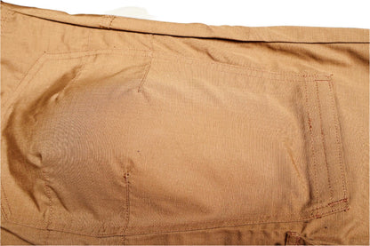 Close-up of a brown fabric with a pocket detail on a beige background