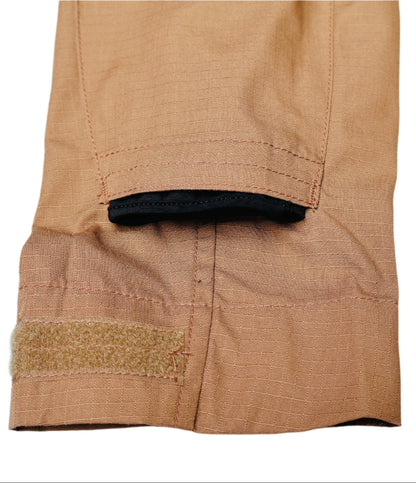 Close-up of a brown fabric with a black trim and gold accent on a white background