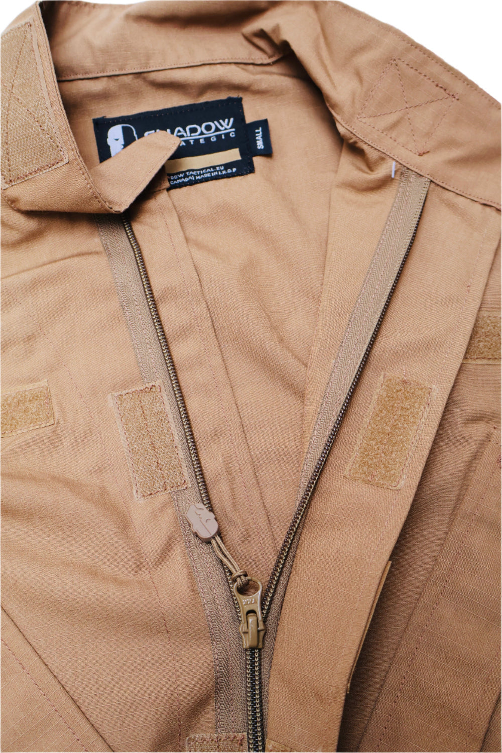 Close-up of a brown jacket with a brand label on a white background